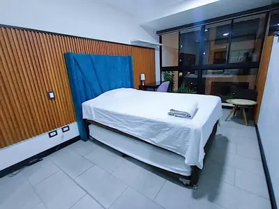 a bedroom with a bed with a blue cover on it at 2BR Deluxe Apartment in San Isidro in Lima