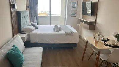 a small room with a bed and a couch at Inca inn apartments in Lima