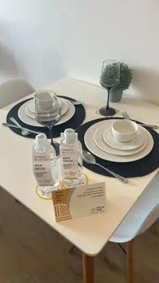 a table with plates and dishes on top of it at Inca inn apartments in Lima