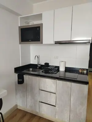 a kitchen with a sink and a counter top at Inca inn apartments in Lima