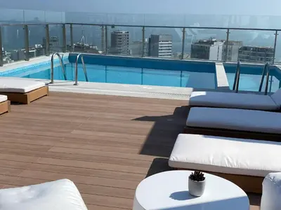 a swimming pool on the roof of a building at Inca inn apartments in Lima