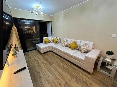 a living room with a couch with yellow pillows at Luxury apartment with panoramic view of San Isidro in Lima