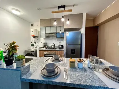 a kitchen with a counter with plates on it at Luxury apartment with panoramic view of San Isidro in Lima
