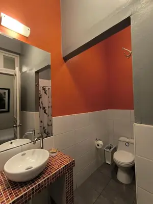 a bathroom with a sink and a toilet at Flying Dog Hostel in Lima