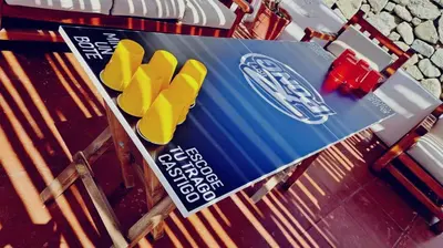 a blue and yellow sign with yellow shoes on a table at Hotel Rustica Lunahuana in Uchupampa