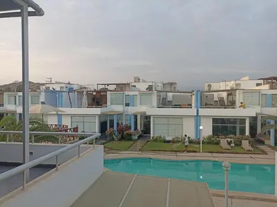 a large apartment building with a pool in front of it at ESCAPA DE LA RUTINA Y DISFRUTA Asia - Chocaya in Asia