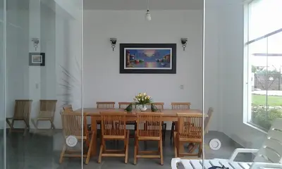 a dining room with a wooden table and chairs at ESCAPA DE LA RUTINA Y DISFRUTA Asia - Chocaya in Asia