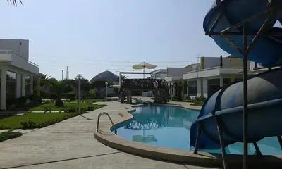 a swimming pool with a slide in a resort at ESCAPA DE LA RUTINA Y DISFRUTA Asia - Chocaya in Asia