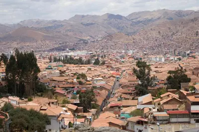 a view of a city with mountains in the background at Casa Campestre on the side of Saqsaywaman in Cusco