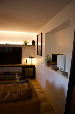 a living room with a couch and a flat screen tv at Casa Campestre on the side of Saqsaywaman in Cusco