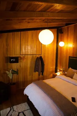 a bedroom with two beds and two lights on the wall at Mountain lodge with Spectacular View in Cusco