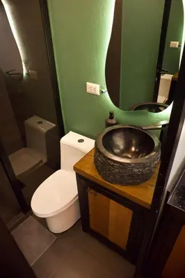a bathroom with a sink and a toilet and a mirror at Mountain lodge with Spectacular View in Cusco