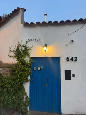 a blue door on the side of a building at Mountain lodge with Spectacular View in Cusco