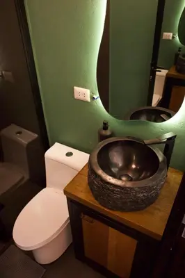 a bathroom with a toilet and a bowl sink at Mountain lodge with Spectacular View in Cusco