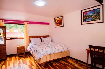 a bedroom with a bed and a window at Intitambo Hotel in Ollantaytambo
