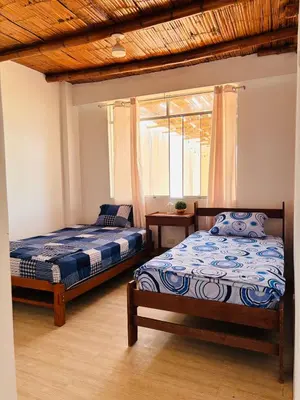 a bedroom with two beds and a window at Casa Puente Azul - Casa de Playa in Cerro Azul