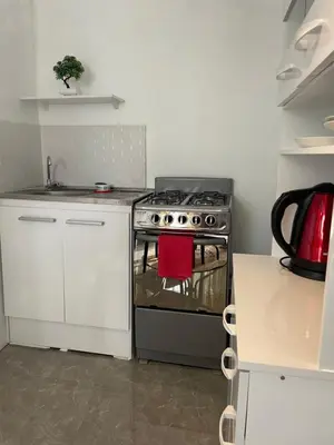 a kitchen with a stove with a red towel on it at Departamento mejor sector de Ica in Ica