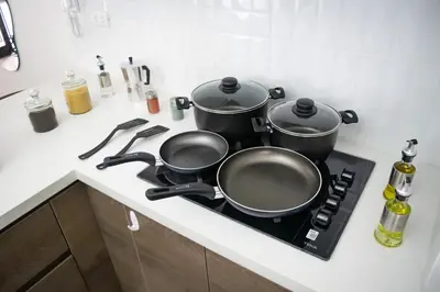 two pots and pans on a stove in a kitchen at Well-Located and Modern Apartment in Barranco in Lima