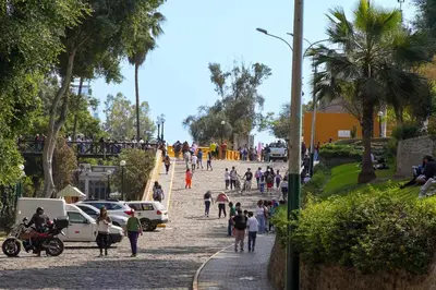 a group of people walking down a street with a steep slope at Well-Located and Modern Apartment in Barranco in Lima
