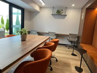 a conference room with a large wooden table and chairs at INTI Studio Apartment in Lima