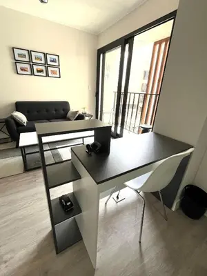 a living room with a desk and a couch at INTI Studio Apartment in Lima