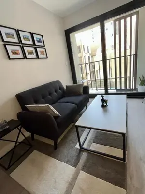 a living room with a couch and a coffee table at INTI Studio Apartment in Lima
