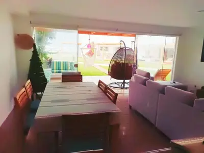 a living room with a table and a couch at Espectacular Casa de Playa en Asia frente al Mar in Asia