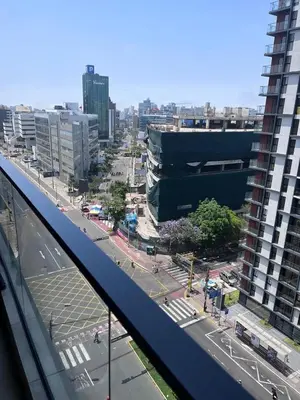 a view of a city with a building and a street at Comfortable accommodation between Lince and San Isidro in Lima