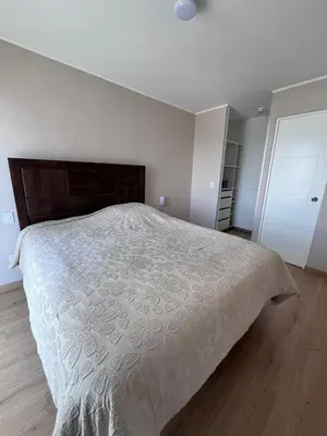 a bedroom with a large bed with a white comforter at Comfortable accommodation between Lince and San Isidro in Lima
