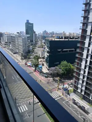 a view of a city with a building and a street at Comfortable accommodation between Lince and San Isidro in Lima