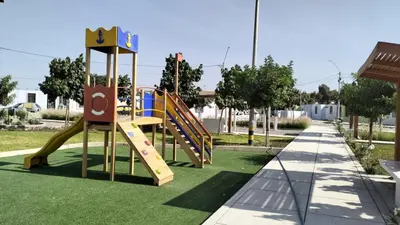 a playground with a slide in a park at Alojamiento Casa en Ica in Ica