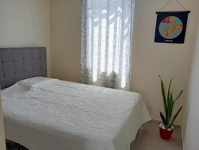 a bedroom with a white bed and a window at Alojamiento Casa en Ica in Ica