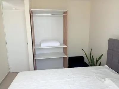 a bedroom with a bed and a white closet at Alojamiento Casa en Ica in Ica