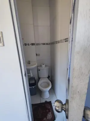 a small bathroom with a toilet and a sink at Casa Conquista in Cusco
