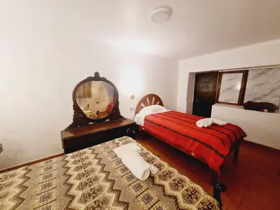 a hotel room with two beds and a mirror at Casa Conquista in Cusco