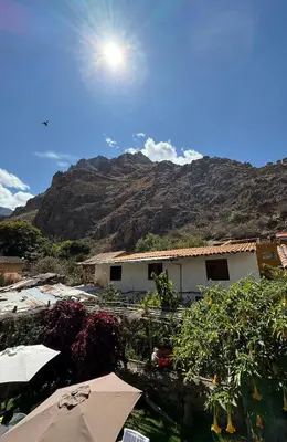 a view of a building with a mountain in the background at Anido Hotel in Ollantaytambo