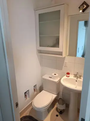 a small bathroom with a toilet and a sink at Departamento con vista al Circuito Mágico del Agua in Lima