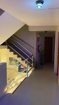 a hallway with a staircase in a building at Hostal El Bosque in Huánuco