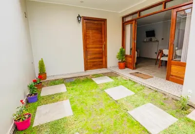 a room with a yard with grass and plants at La covacha de viejo in Jauja
