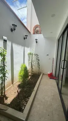 a building with a courtyard with plants and a window at Malka Casas - Hoteles in Marco
