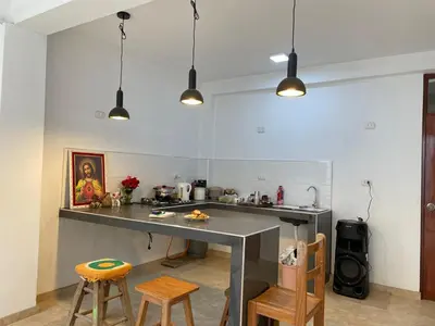 a kitchen with a counter and some chairs in a room at Malka Casas - Hoteles in Marco