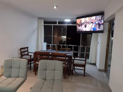 a living room with a dining table and a flat screen tv at Macky'sThe Silence in Bombiso