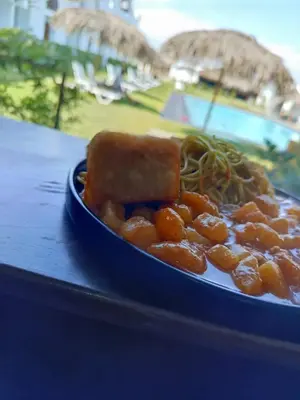 a blue plate of food with spaghetti and noodles at Hotel Kendari - Chincha in Chincha