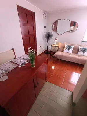 a living room with a couch and a table at La Palmera in Lima