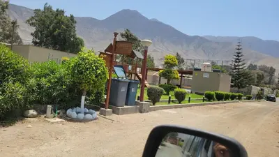 a side view mirror of a car driving down a road at Villa MAS - Condominio Hacienda II in Pachacamac