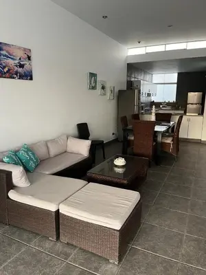 a living room with a couch and a table at Linda Casa en Condominio in Asia