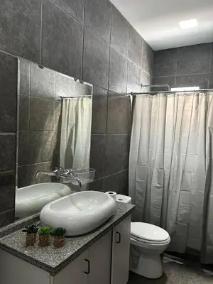 a bathroom with a sink and a toilet and a shower at Linda Casa en Condominio in Asia