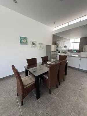 a kitchen with a dining room table and chairs at Linda Casa en Condominio in Asia