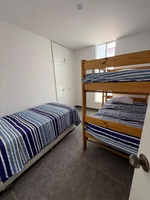a bedroom with two bunk beds and a window at Linda Casa en Condominio in Asia