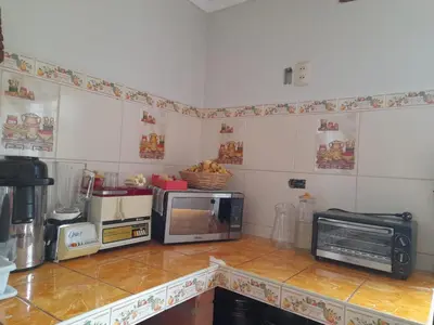 a kitchen with a counter with a microwave and a microwave at Pisonaywasi - Hospedaje familiar in Urubamba